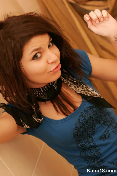 Skinny Brunette with a Tattoo Poses and Shows Her Cleavage – photo 14 of 15