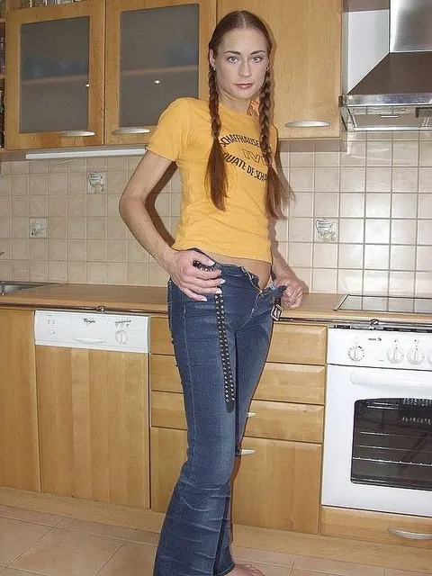 Tall European in Pigtails Strips and Spreads in the Kitchen – photo 3 of 21