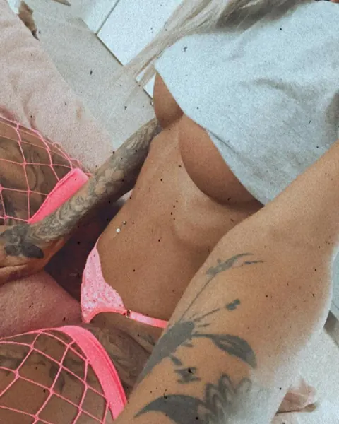 Busty Tattooed MILF Poses in Pink Fishnet Lingerie – photo 6 of 12
