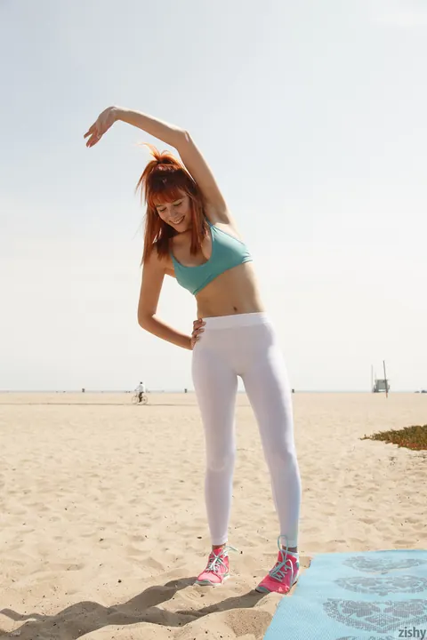 Penelope Lynn: Busty Tattooed Redhead Poses in Yoga Moves on the Beach – photo 1 of 12