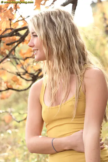Slim Blonde Strips Out of Her Skirt Outdoors Under a Tree