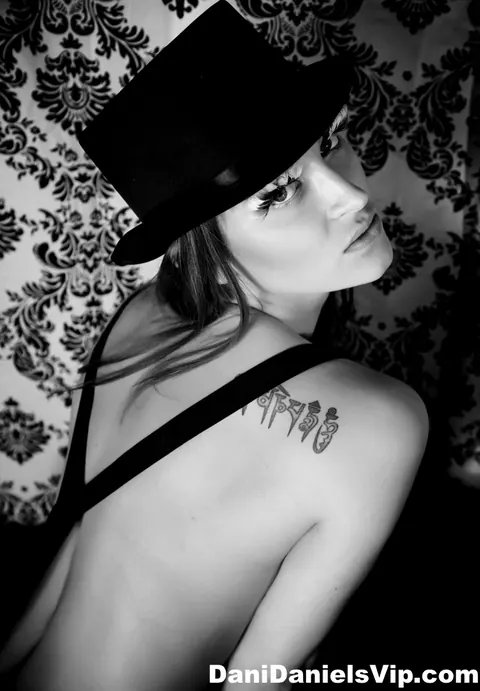 Dani Daniels: Busty Brunette in Panties Poses Topless in a Top Hat – photo 3 of 15
