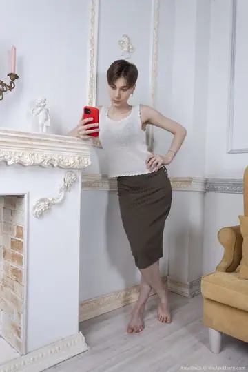 Amelinda – Amateur Brunette with Short Hair Displays Her Hairy Pussy on the Sofa