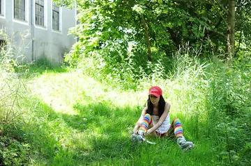 Busty Tattooed Brunette Uses a Dildo Outdoors in Socks