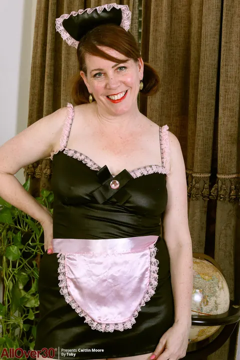 Caitlin Moore: Busty Redhead MILF Strips Off Her Maid Uniform in Stockings and Heels – photo 2 of 15