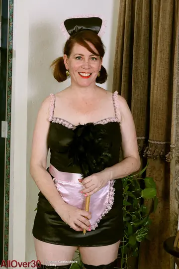 Busty Redhead MILF Strips Off Her Maid Uniform in Stockings and Heels