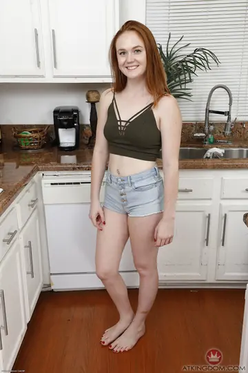 Redhead Strips Nude and Poses for the Camera