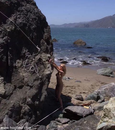 Sadie Belle: Curly Blonde MILF in Glasses Tied Nude to a Beach Rock – photo 11 of 17