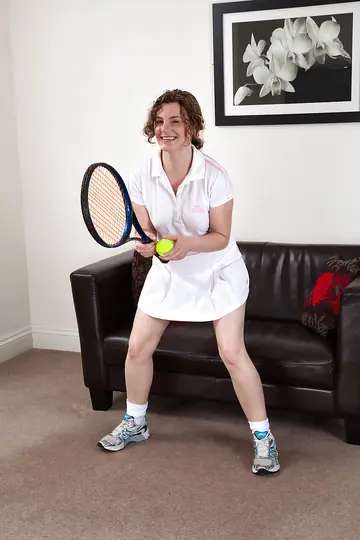 Curly MILF Lifts Her Tennis Skirt to Flash Her Hairy Bush