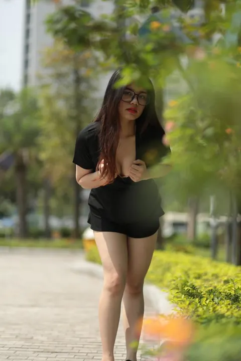 Petite Asian Brunette in Glasses Poses Outdoors in a Dress – photo 17 of 21