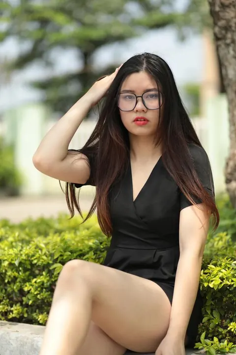 Petite Asian Brunette in Glasses Poses Outdoors in a Dress – photo 9 of 21