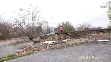 European Brunette Pisses and Spreads Her Legs Clothed at an Abandoned Site