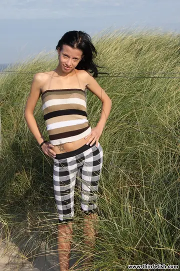 Slim Brunette with Natural Tits Spreads Her Ass on the Beach