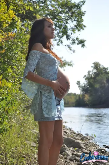 Pregnant Brunette Shows Her Belly and Ass on a River Beach