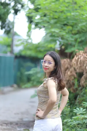 Woman Stands Nude and Displays Her Figure for Camera