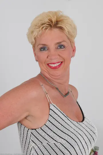 Mature Blonde Strips Out of Her Dress and Shows Her Big Tits