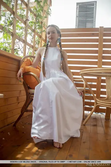 Brunette in Braided Pigtails Lifts Her Skirt to Reveal Her Shaved Pussy
