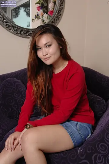 Asian Brunette Strips Off Her Skirt and Fingers Her Shaved Pussy