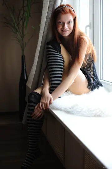 Slim Redhead Spreads Her Shaved Pussy in Stockings