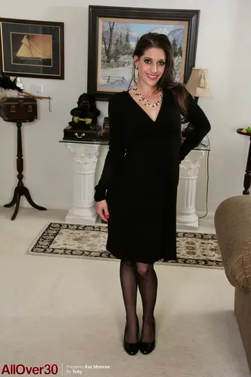 Mature Brunette MILF in a Dress and Stockings Spreads Her Shaved Pussy