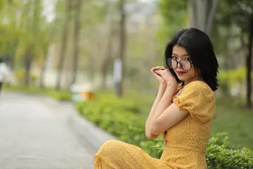 Short-Haired Woman in Glasses Poses Outdoors