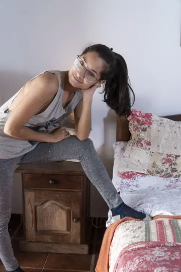 Short-Haired Woman in Glasses Spreads Her Hairy Pussy on the Bed