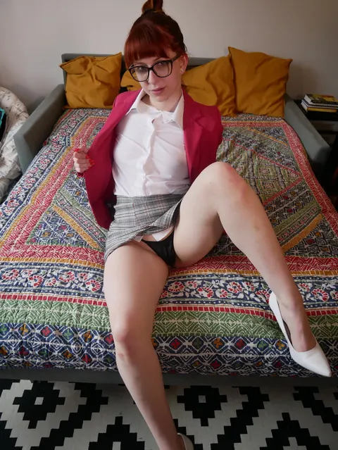 Redhead in a Skirt and Glasses Spreads Her Legs to Show Panties – photo 9 of 14