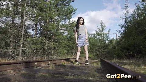 Brunette Lifts Her Skirt and Pisses on Railway Tracks – photo 1 of 15