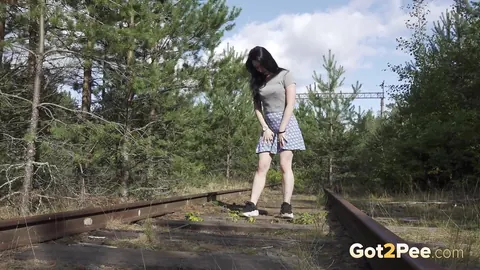 Brunette Lifts Her Skirt and Pisses on Railway Tracks – photo 2 of 15