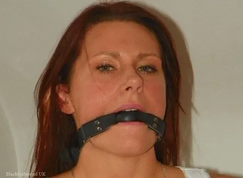 Tattooed Redhead Bound and Gagged on the Bed Spreads Her Legs – photo 13 of 14