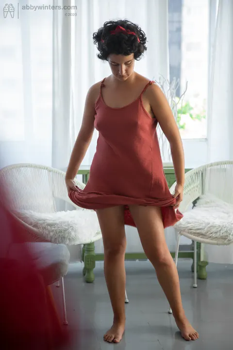 Curly Brunette Lifts Her Red Dress to Show Panties – photo 18 of 21