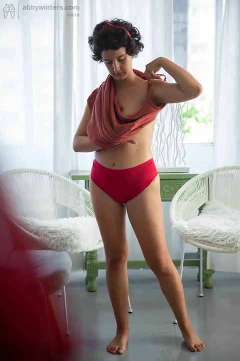 Curly Brunette Lifts Her Red Dress to Show Panties – photo 16 of 21