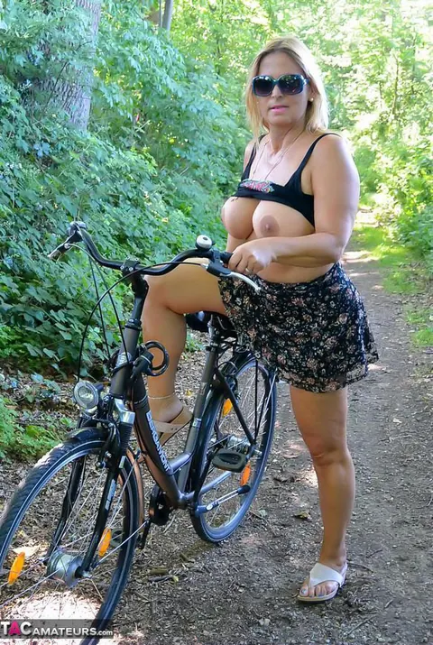 Nudechrissy: Mature European Blonde Rides a Bicycle Topless in a Skirt Outdoors – photo 3 of 20