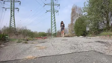 Tall Slim Brunette Pisses in Her Boots on a Paved Road