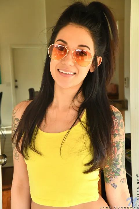 Jynx Correra: Tattooed Brunette in Glasses Strips and Fingers Her Pussy – photo 1 of 16