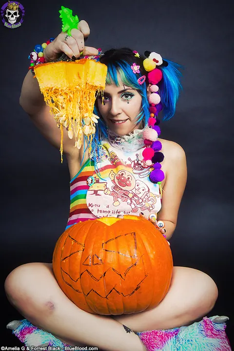 Woman with Pigtails Strips While Carving a Pumpkin and Spreads – photo 1 of 15