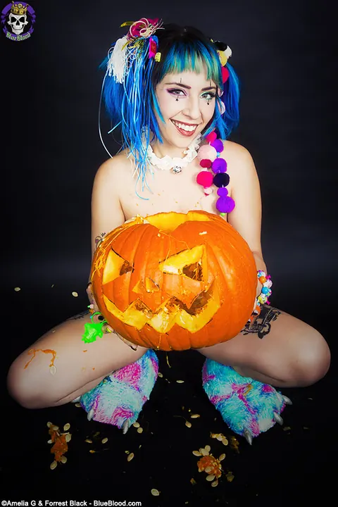 Woman with Pigtails Strips While Carving a Pumpkin and Spreads – photo 10 of 15