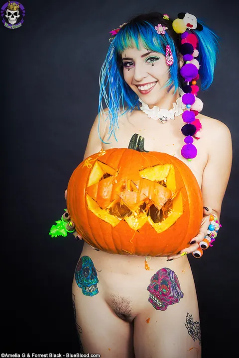 Woman with Pigtails Strips While Carving a Pumpkin and Spreads – photo 9 of 15
