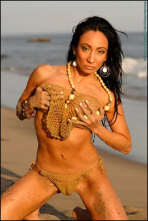 Monica Goe: Busty Latina Poses in a Bikini and Strips Topless on the Beach – photo 12 of 15