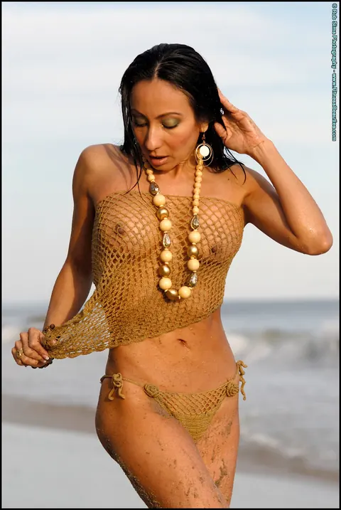 Monica Goe: Busty Latina Poses in a Bikini and Strips Topless on the Beach – photo 7 of 15