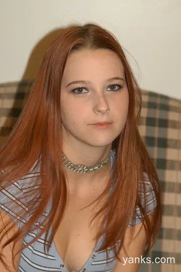 Redhead in a Skirt and Lingerie Fingers Her Pussy