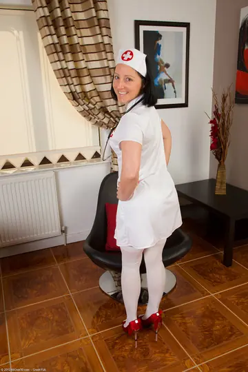 Mature Brunette Nurse in Glasses Spreads Her Shaved Pussy