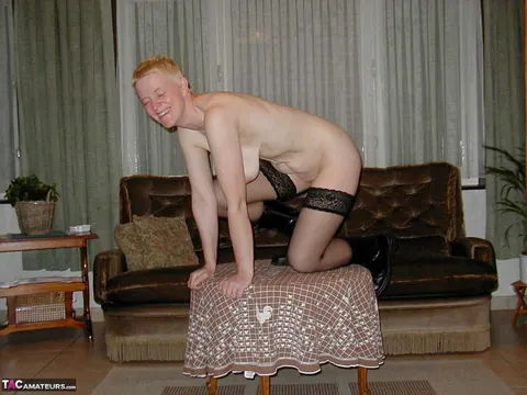 Tiffany Pearl: Mature Blonde Sheds Her Stockings and Boots on Leather Sofa – photo 9 of 16