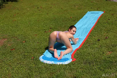 Nicole Auclair: Brunette in a Bikini and Panties Spreads on a Garden Slide – photo 5 of 16