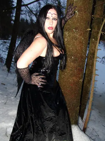 Brunette MILF with Big Tits Opens Latex Costume and Poses Nude in Woods