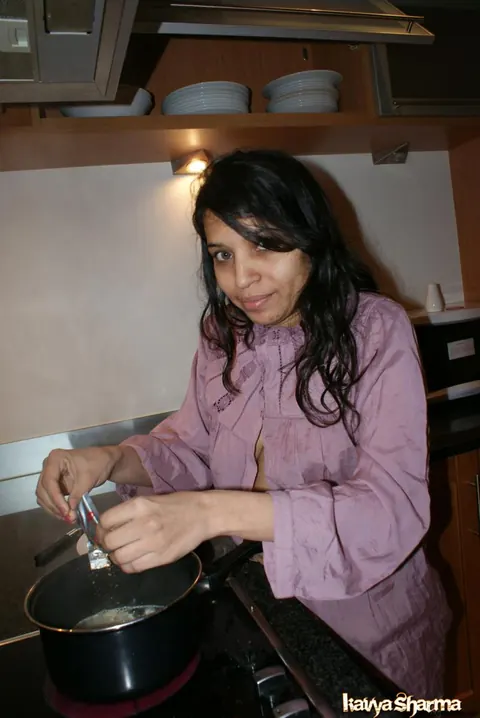 Kavya Sharma: Busty Indian MILF Strips Out of Her Shorts on the Sofa – photo 1 of 12