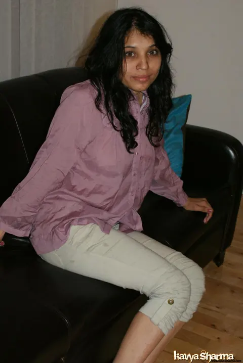 Kavya Sharma: Busty Indian MILF Strips Out of Her Shorts on the Sofa – photo 5 of 12