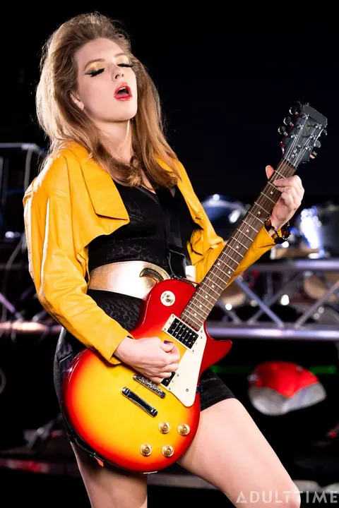 Charlotte Stokely: Busty Blonde and Brunette Kiss in Leather Skirts on Stage – photo 11 of 15