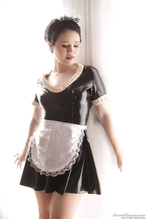Yhivi: Brunette in Latex Maid Uniform Strips by the Window – photo 3 of 15