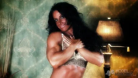 Debbie Bramwell: Brunette MILF Flexes Her Muscles and Shows Pierced Belly in the Gym – photo 2 of 21